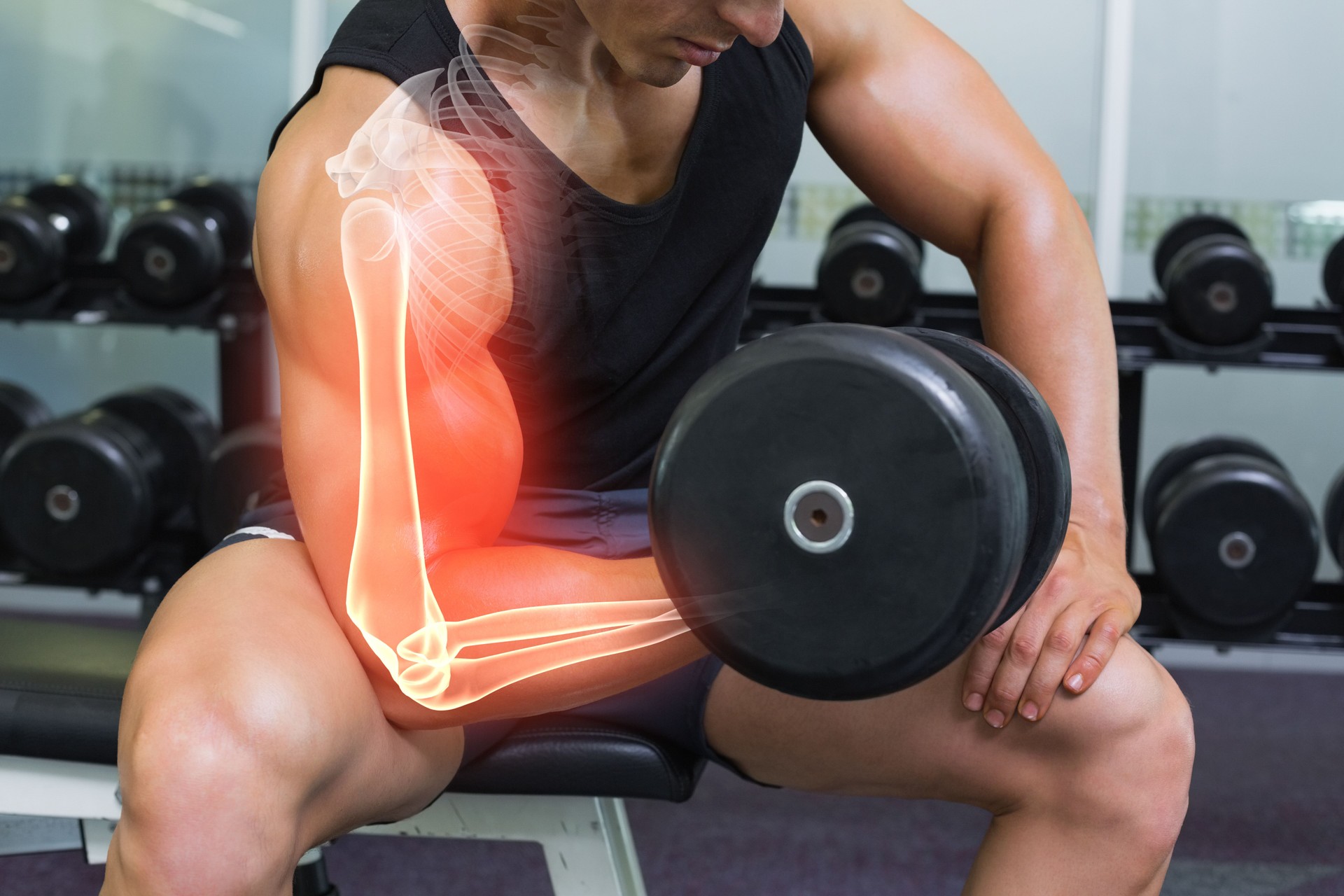 Highlighted arm of strong man lifting weights