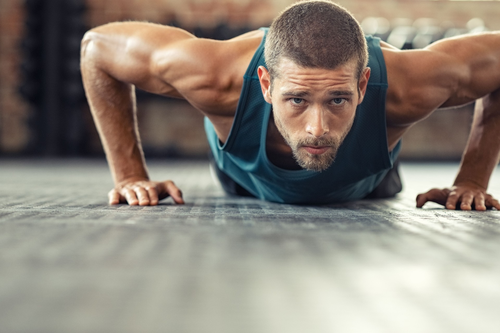 Determined man doing push ups at the gym