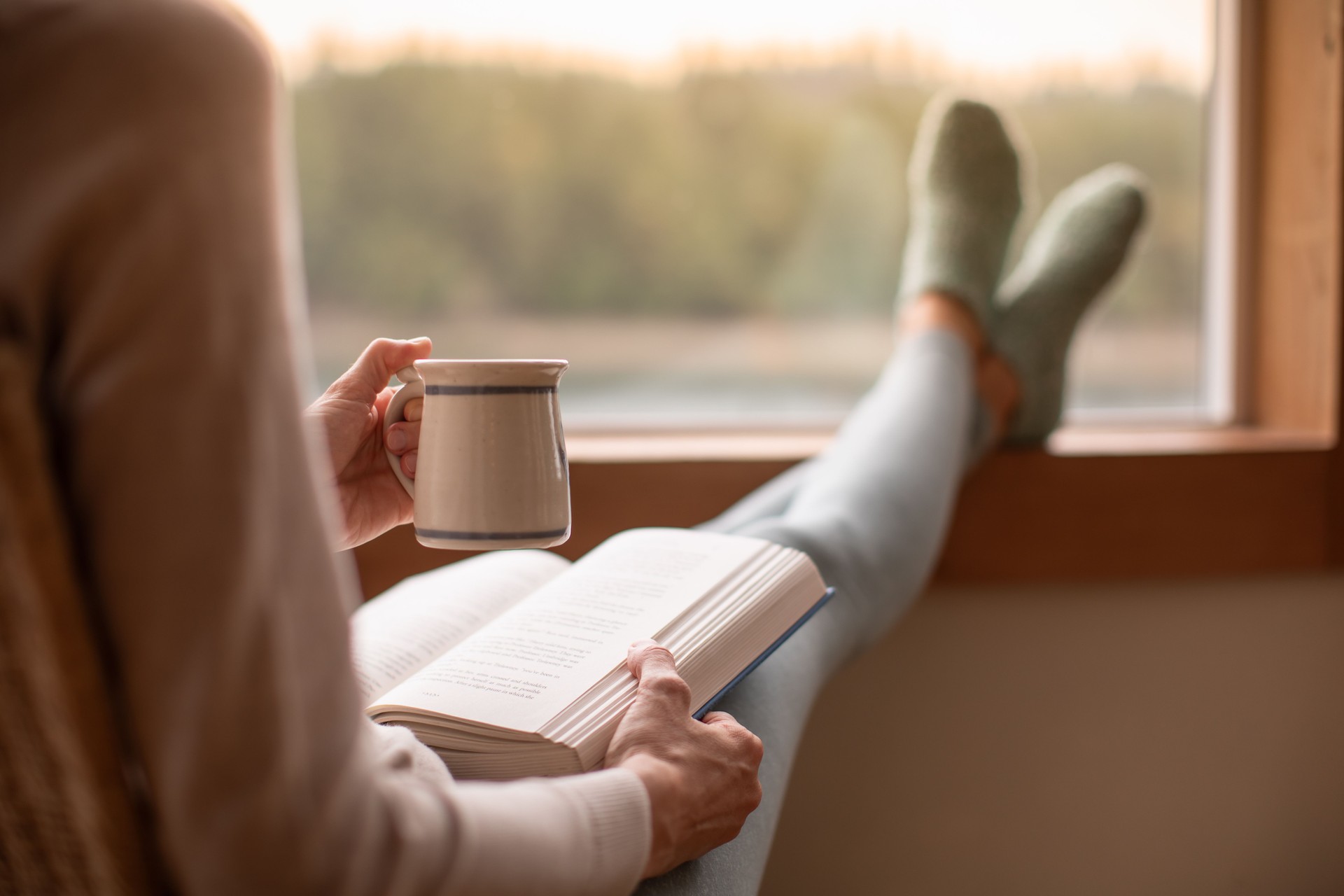Woman reading a book at home.