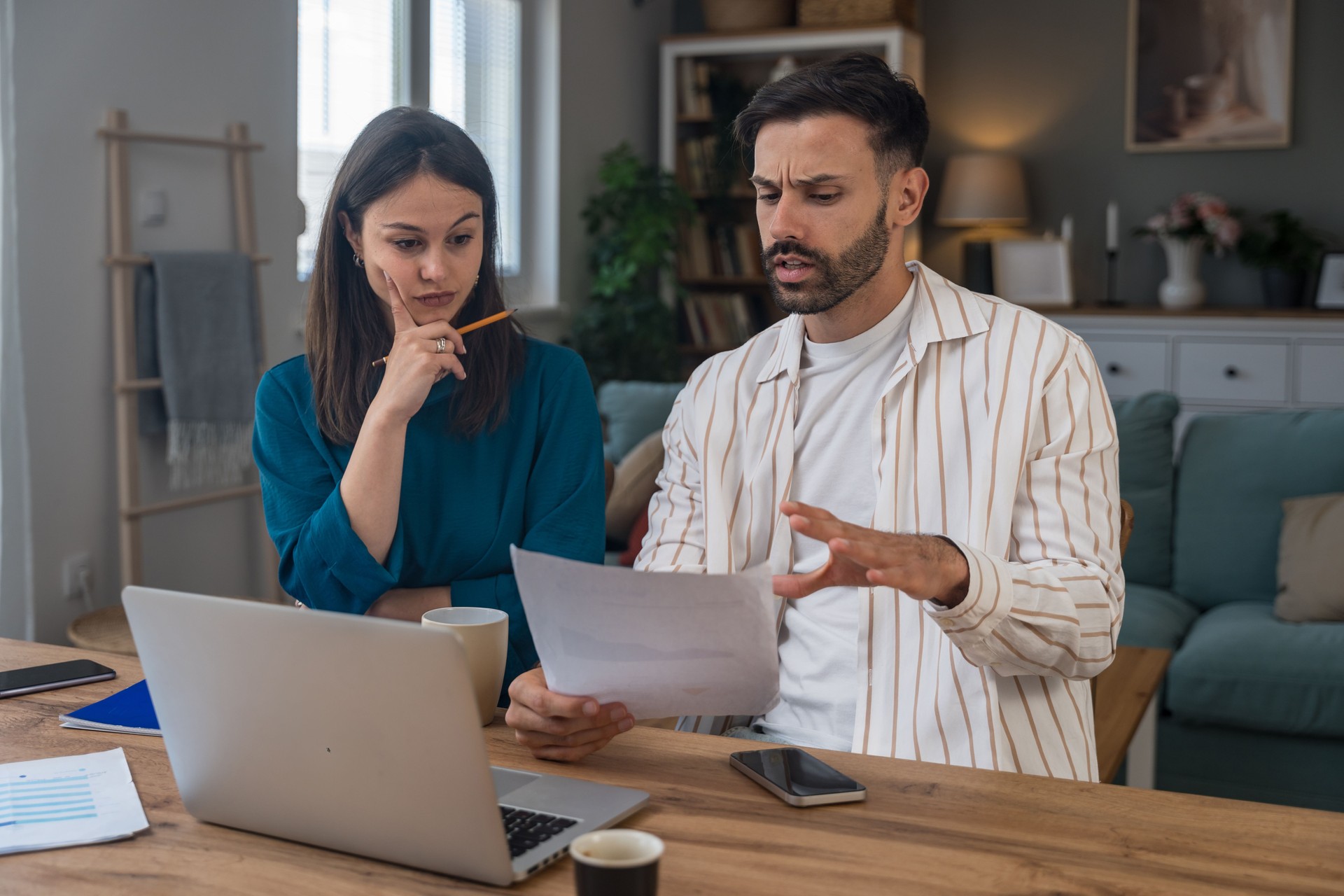Finance and economy. Young couple, small business owners, working online at home office, preparing for video call for presentation and online coaching. E-commerce man and woman professional occupation